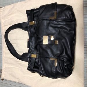 Michael Kors Black Handbag with Gold trim accents.